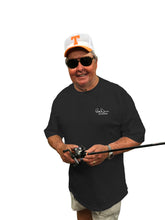 Load image into Gallery viewer, Lifestyle photo of front profile of a Bill Dance wearing his “Work” short sleeve t-shirt