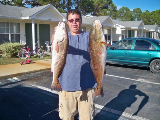 The redfish on the left-side was caught by my buddy Robby it was 24