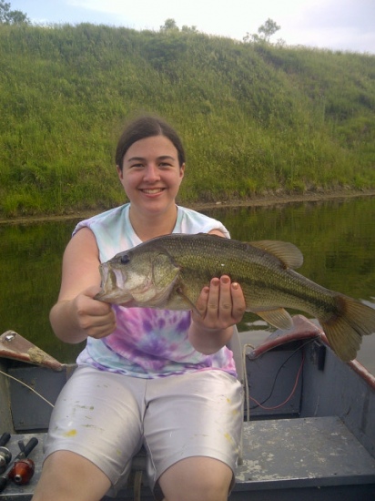 I am proudly submitting this picture of a bass my 18 year olf daughter, Morgan Anderson, caught on Memorial Day weekend 2012.  This came from our strip pits located near Clinton Missouri.  She caught it on a green grass frog.  It weighed 7 lbs 4 ounces.  The bass was released after the photo