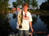 This is a photo of my wife with a 6 lbs 8 oz large mouth bass caught in a Interstate pond in North west  Illinois.She loves to fish them, we caught lots of fish, this is the biggest she has ever caught.We were throughing a white mouse on top.