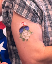 Load image into Gallery viewer, Tattoo of a fish wearing sunglasses and a cap on a person&#39;s arm